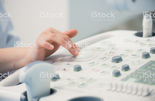 young woman doctor's hands close up preparing for an ultrasound device scan